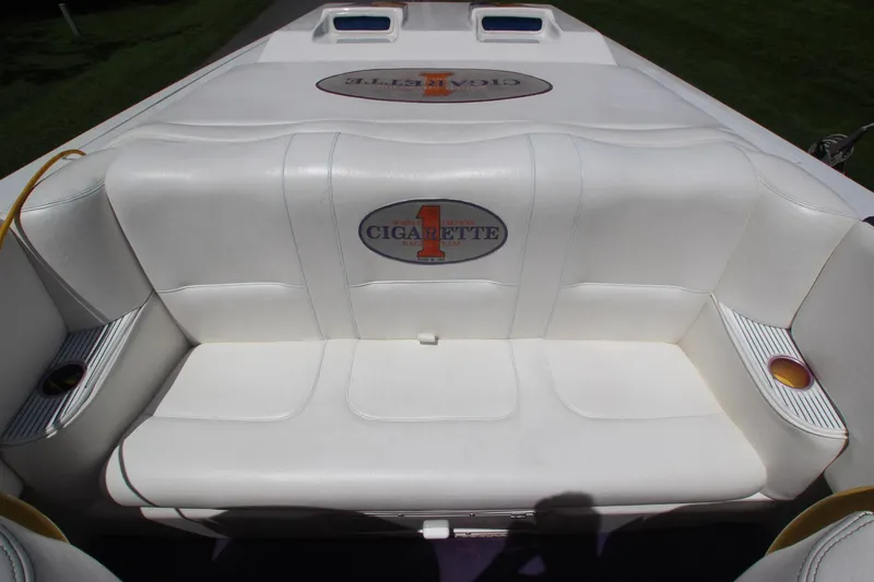Slide: The Image of 2001 Cigarette 46 Rough Rider boat interior with white seating and logo. - 13