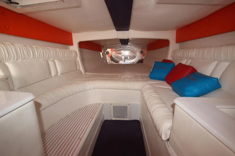 Slide: The Image of Interior of 2001 Cigarette 46 Rough Rider boat with cushioned seating and colorful pillows. - 15