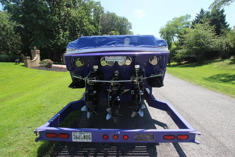 Slide: The Image of Rear view of a 2001 Cigarette 46 Rough Rider boat on a trailer. - 30