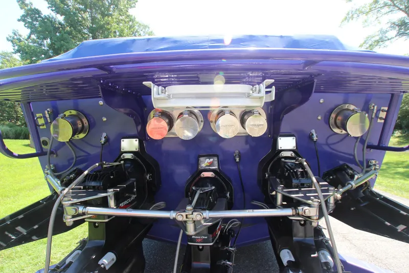 Slide: The Image of Rear view of a 2001 Cigarette 46 Rough Rider boat with visible engine components. - 31
