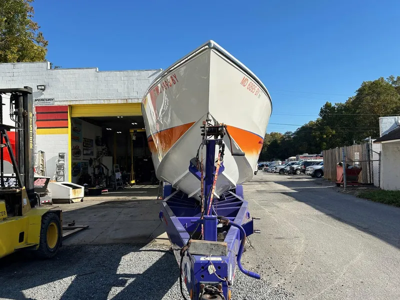 Slide: The Image of 2001 Cigarette 46 Rough Rider boat on trailer outside a garage. - 36