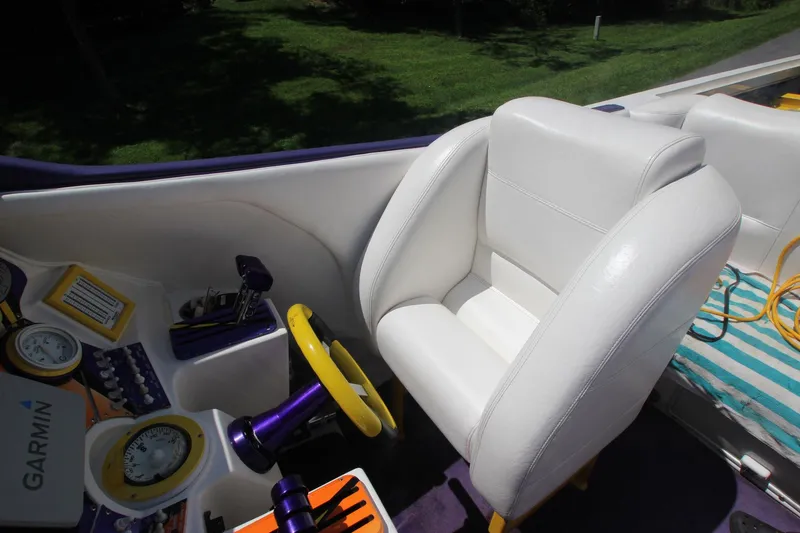 Slide: The Image of Interior of 2001 Cigarette 46 Rough Rider boat with white seating and navigation controls. - 7