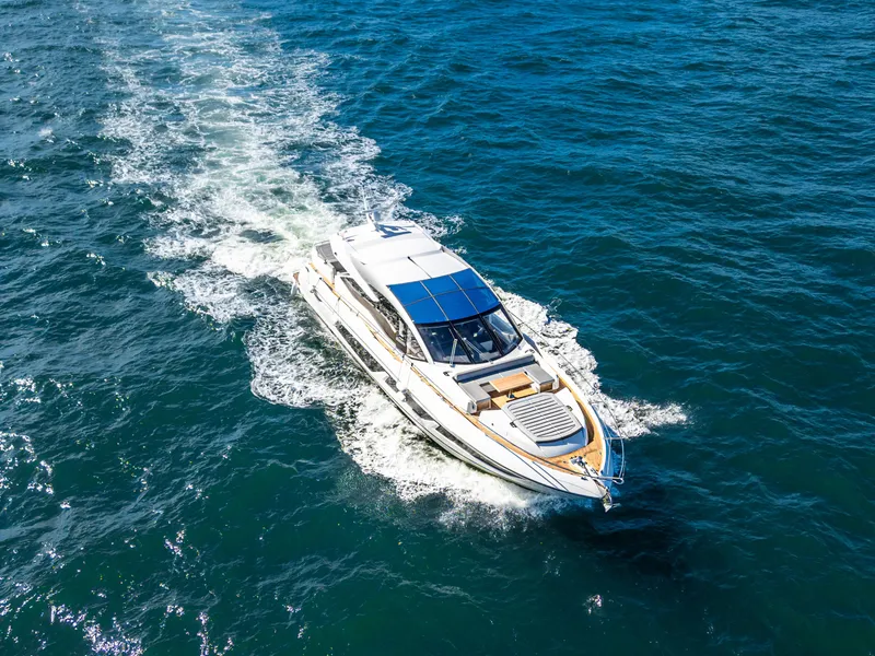 Slide: The Image of 2020 Sunseeker Predator 74 yacht cruising on open blue water. - 15