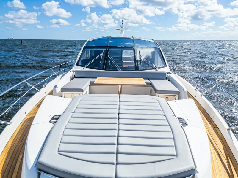 Slide: The Image of 2020 Sunseeker Predator 74 yacht on open sea, featuring sleek design and spacious deck. - 17