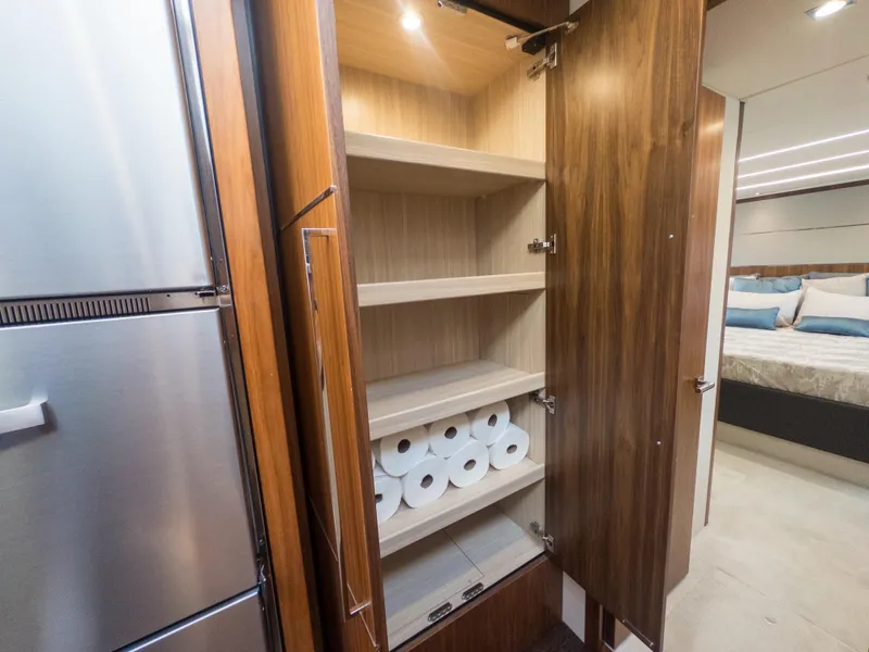 Slide: The Image of Luxury yacht Sunseeker Predator 74 interior, featuring a wooden storage cabinet with shelves. - 29