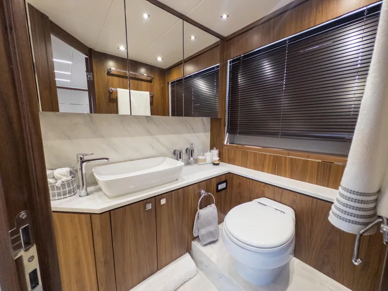 Slide: The Image of Luxurious bathroom in 2020 Sunseeker Predator 74 yacht with modern fixtures and wood accents. - 39