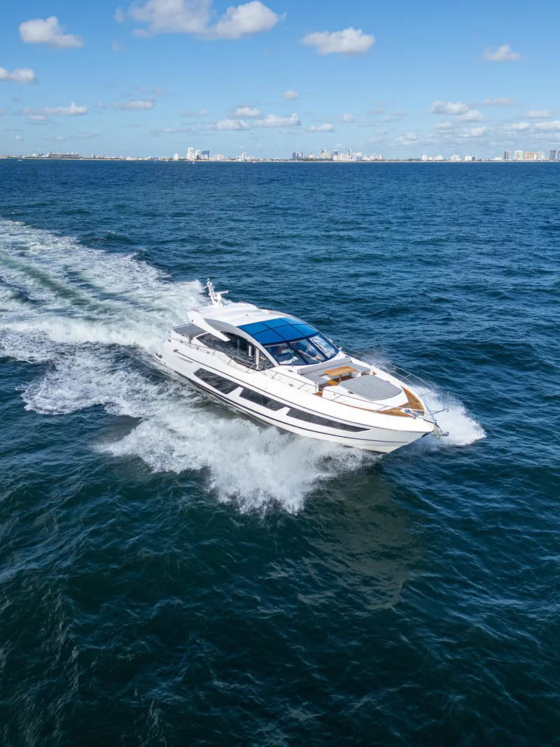 Slide: The Image of 2020 Sunseeker Predator 74 yacht cruising on open sea under blue sky. - 6