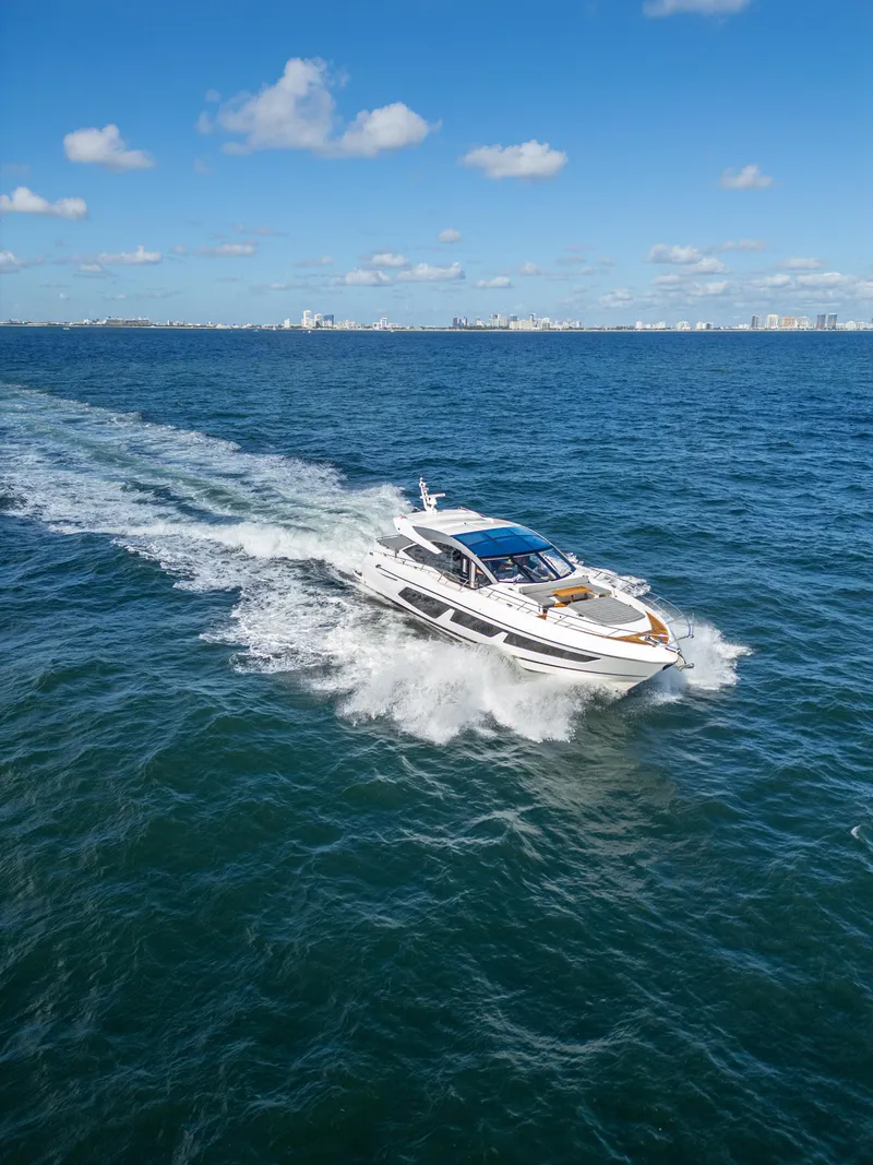 Slide: The Image of 2020 Sunseeker Predator 74 yacht cruising on open sea under clear blue sky. - 7