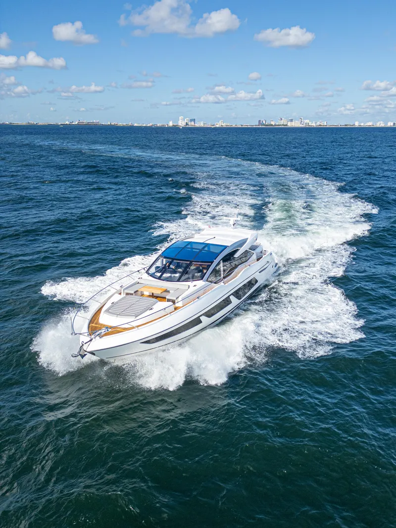 Slide: The Image of 2020 Sunseeker Predator 74 yacht cruising on open sea under blue sky. - 8