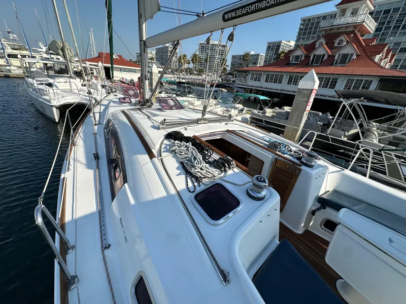 Slide: The Image of Beneteau Oceanis 40 sailboat, 2011 model, docked at marina with other boats. - 11