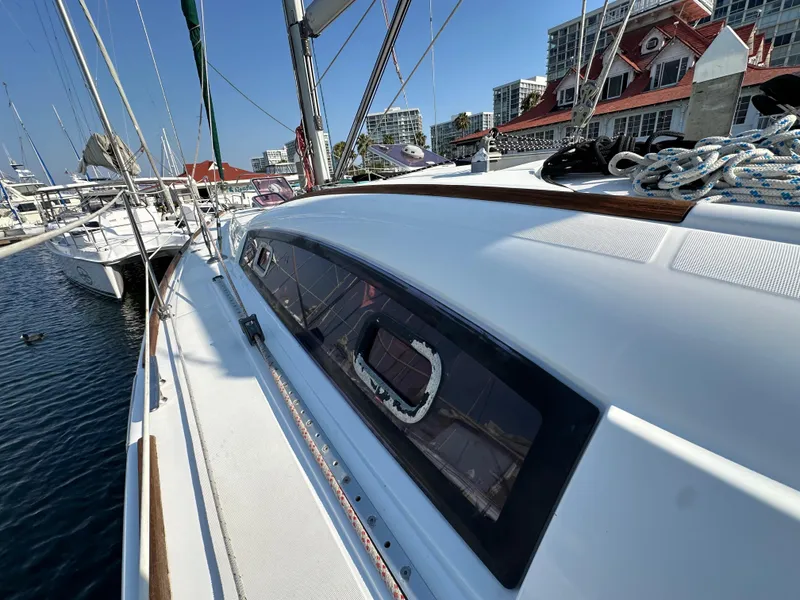 Slide: The Image of Beneteau Oceanis 40 sailboat, 2011 model, docked at marina with cityscape background. - 12