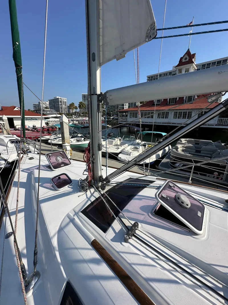 Slide: The Image of 2011 Beneteau Oceanis 40 sailboat docked at marina with clear blue sky. - 13