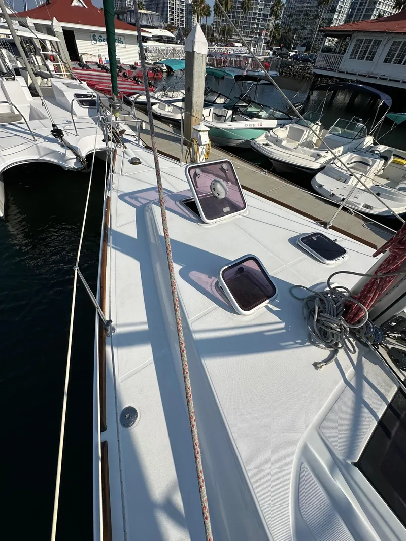 Slide: The Image of 2011 Beneteau Oceanis 40 sailboat deck with open hatches, docked at marina. - 15