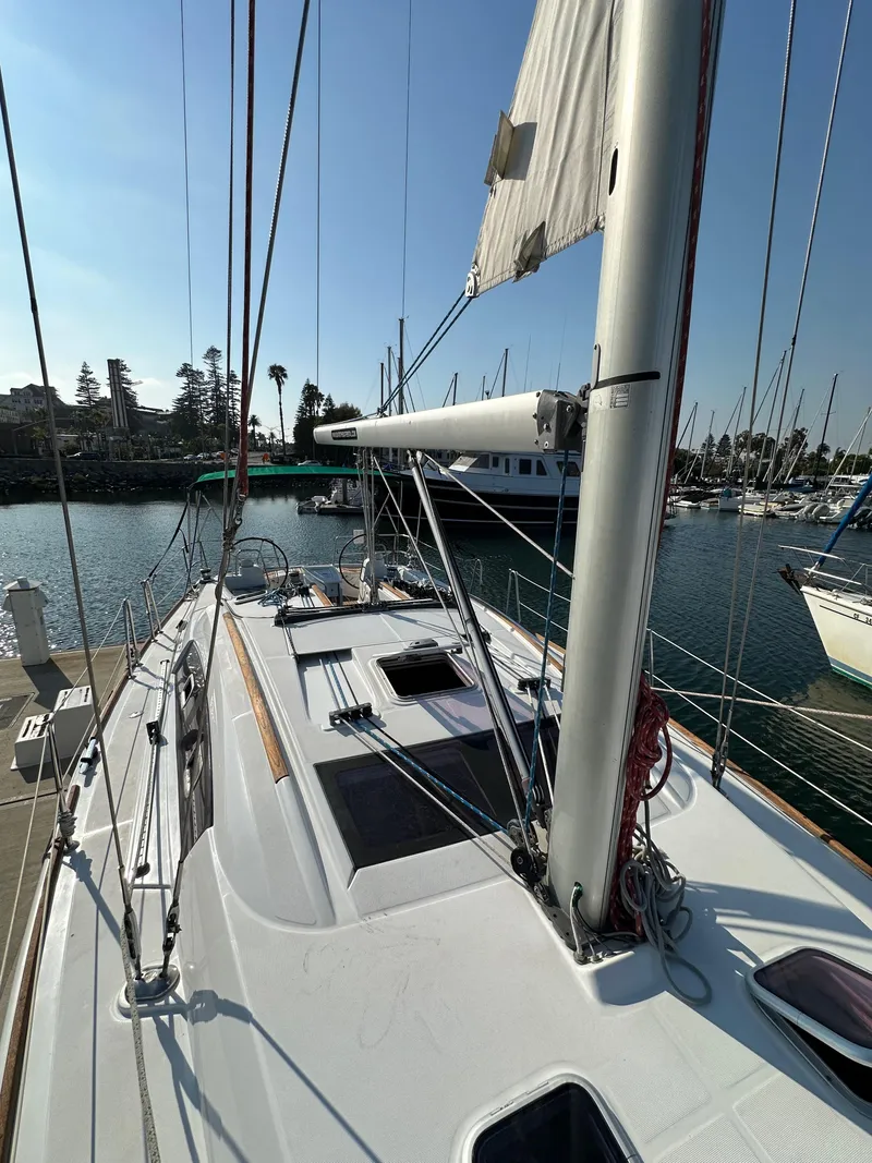 Slide: The Image of 2011 Beneteau Oceanis 40 sailboat docked in a sunny marina. - 21