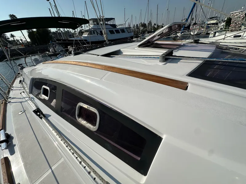 Slide: The Image of 2011 Beneteau Oceanis 40 sailboat deck with sleek design in marina setting. - 22