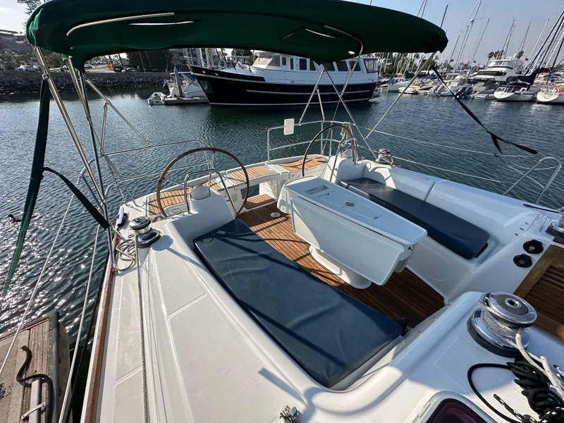 Slide: The Image of 2011 Beneteau Oceanis 40 sailboat cockpit with green canopy, docked in marina. - 24
