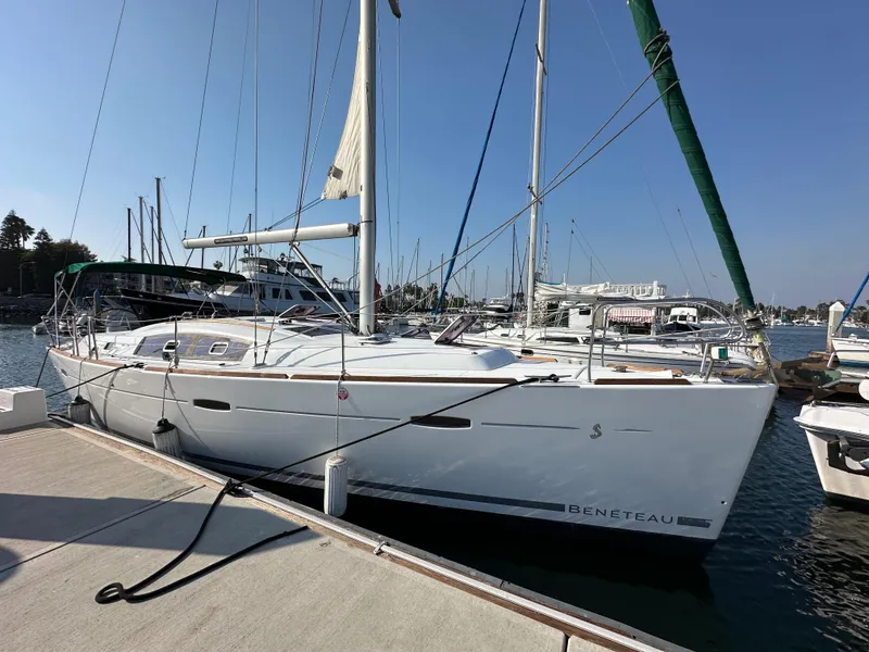 Slide: The Image of 2011 Beneteau Oceanis 40 sailboat docked at marina under clear blue sky. - 3