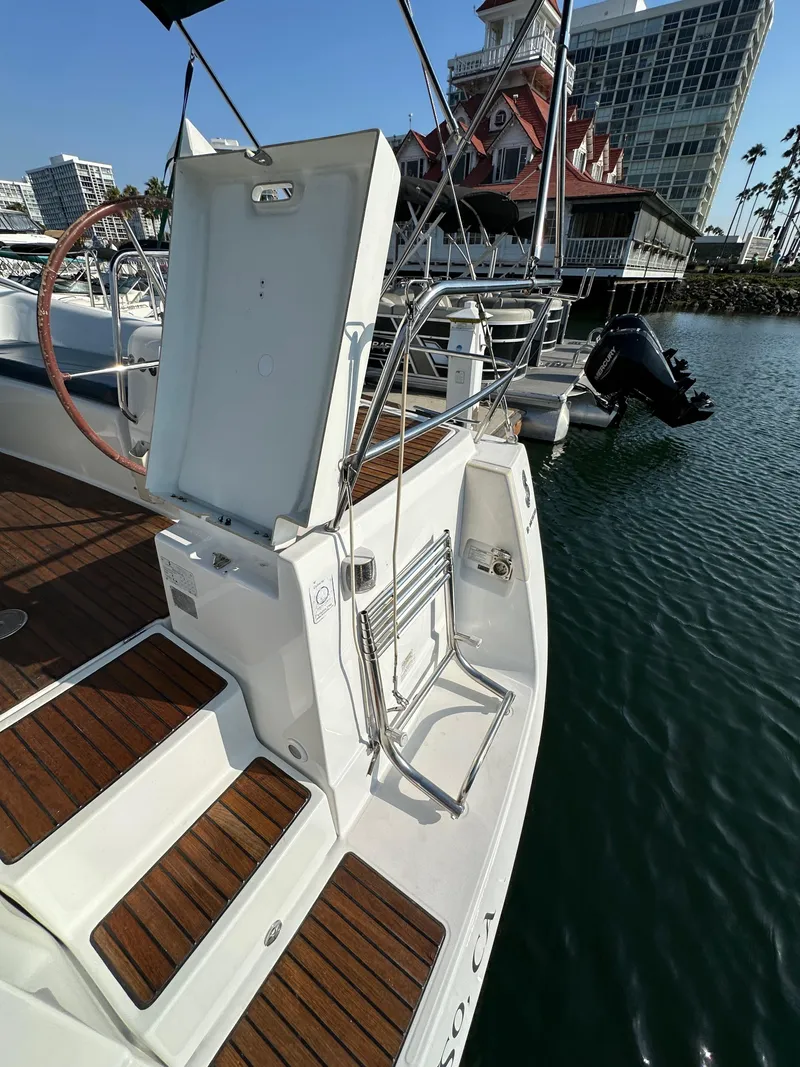 Slide: The Image of 2011 Beneteau Oceanis 40 yacht with open hatch, docked near waterfront buildings. - 30