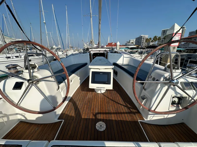 Slide: The Image of 2011 Beneteau Oceanis 40 sailboat cockpit with dual steering wheels and wooden deck. - 34