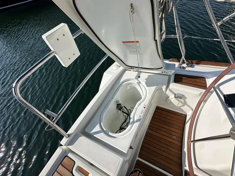 Slide: The Image of Beneteau Oceanis 40 sailboat deck, 2011 model, featuring open storage compartment and wooden flooring. - 36
