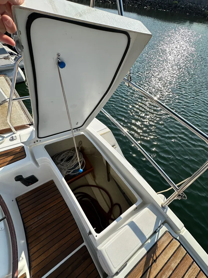 Slide: The Image of Open storage compartment on 2011 Beneteau Oceanis 40 sailboat, docked by the water. - 37