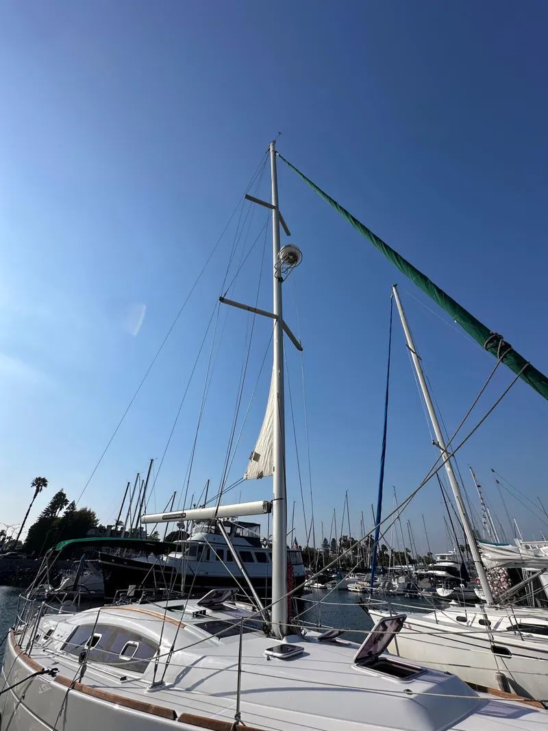 Slide: The Image of 2011 Beneteau Oceanis 40 sailboat docked under clear blue sky. - 4