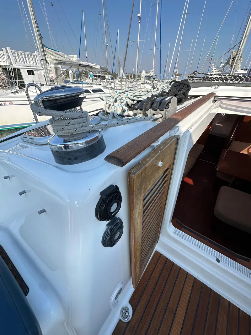 Slide: The Image of Beneteau Oceanis 40 sailboat deck, 2011 model, with winch and ropes in a marina setting. - 44