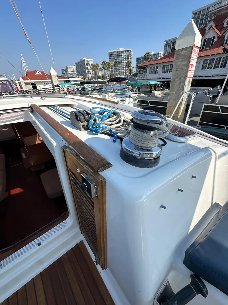 Slide: The Image of 2011 Beneteau Oceanis 40 sailboat deck with winch and ropes in marina setting. - 45