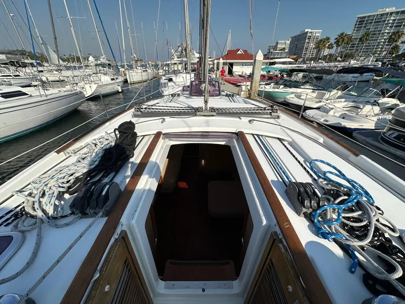 Slide: The Image of Beneteau Oceanis 40 sailboat, 2011 model, docked in a marina with open cabin view. - 46