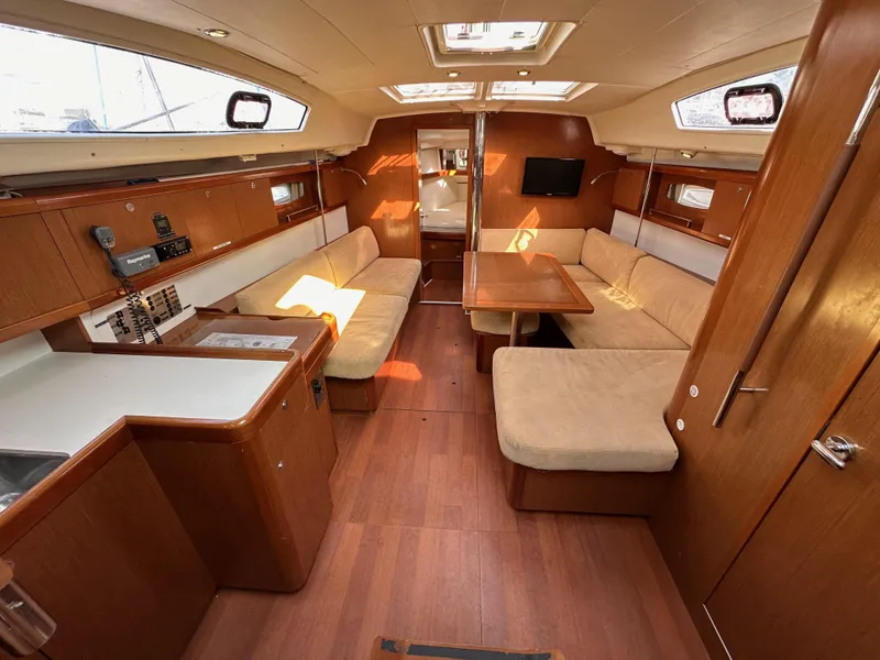 Slide: The Image of Interior of 2011 Beneteau Oceanis 40 sailboat with wood finish and beige seating. - 47