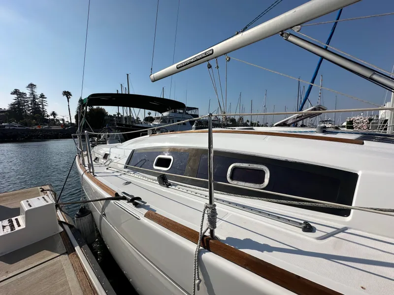 Slide: The Image of 2011 Beneteau Oceanis 40 sailboat docked in marina under clear blue sky. - 6