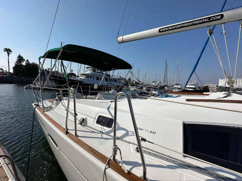 Slide: The Image of Sailboat Beneteau Oceanis 40, 2011 model, docked in a marina under clear skies. - 7