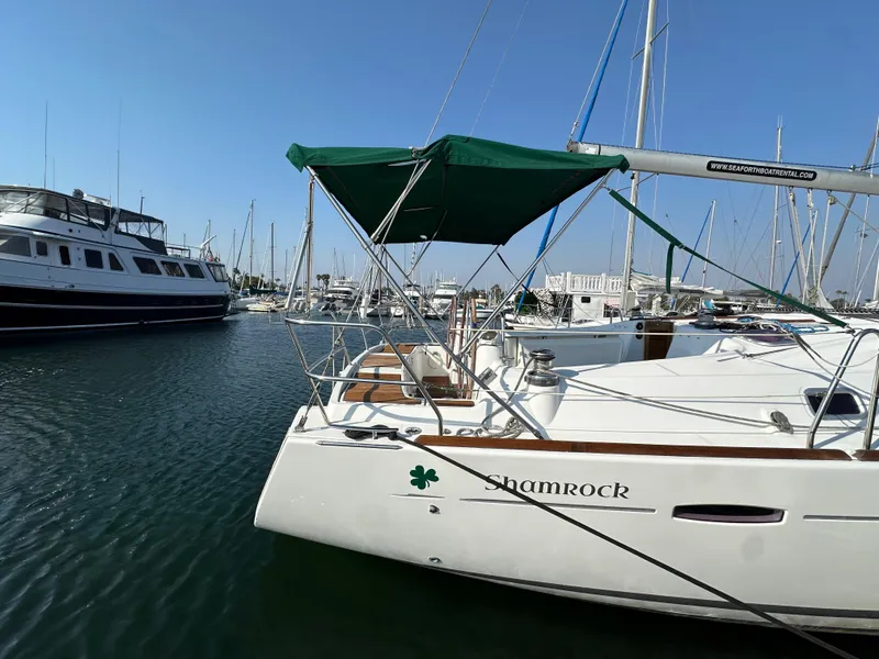 Slide: The Image of Beneteau Oceanis 40 sailboat, 2011 model, docked in a marina with green canopy. - 8