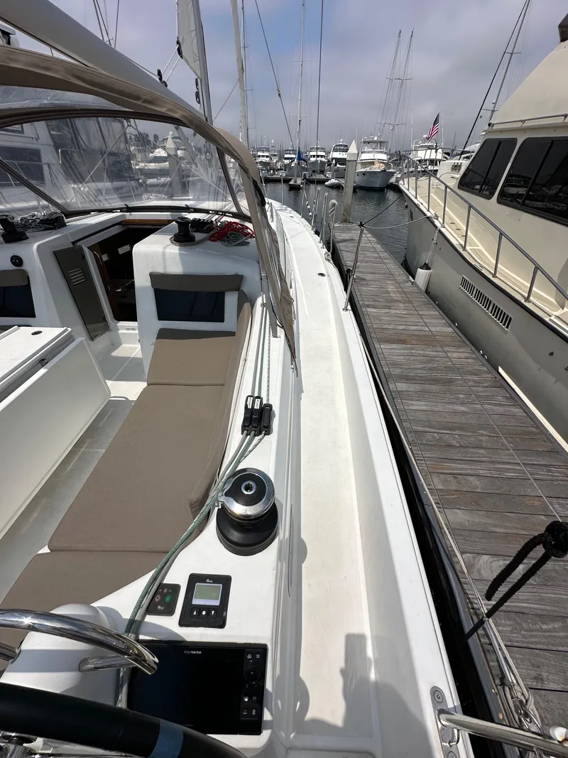 Slide: The Image of 2020 Jeanneau Sun Odyssey 410 sailboat docked at marina, showcasing deck and cockpit area. - 23