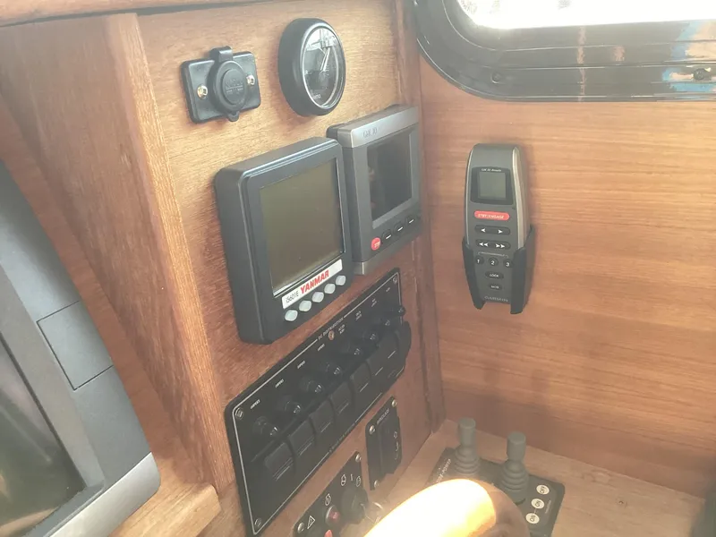 Slide: The Image of 2012 Ranger Tugs R-27 boat dashboard with navigation controls and instruments. - 10