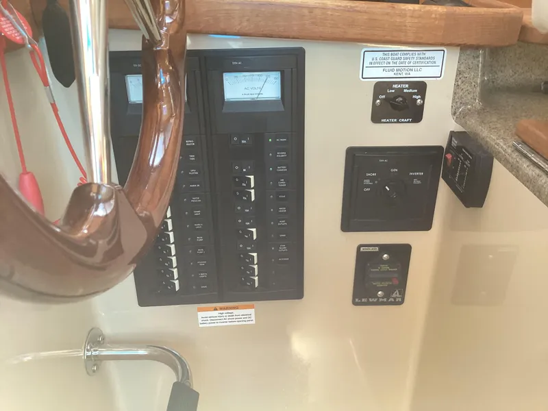 Slide: The Image of Control panel of a 2012 Ranger Tugs R-27 boat with switches and gauges. - 11