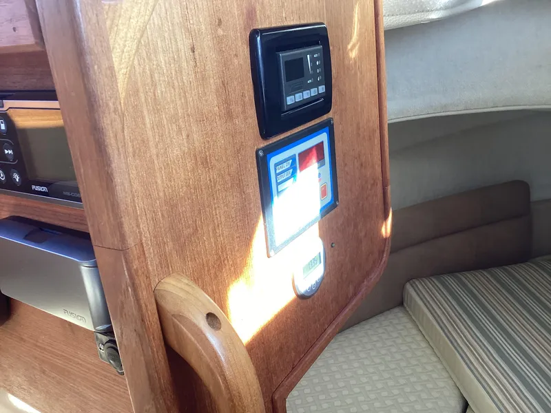 Slide: The Image of Interior of 2012 Ranger Tugs R-27 boat with control panel and seating area. - 15