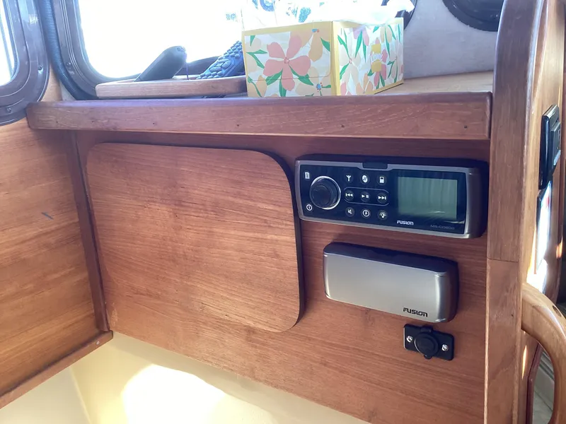 Slide: The Image of 2012 Ranger Tugs R-27 interior with Fusion stereo system and wooden cabinetry. - 16