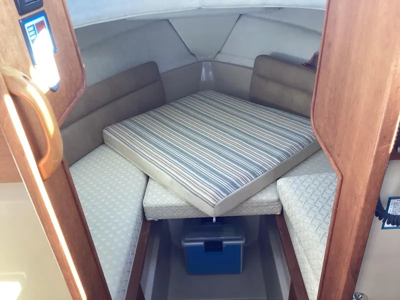 Slide: The Image of Interior cabin of 2012 Ranger Tugs R-27 with cushioned seating and compact design. - 18