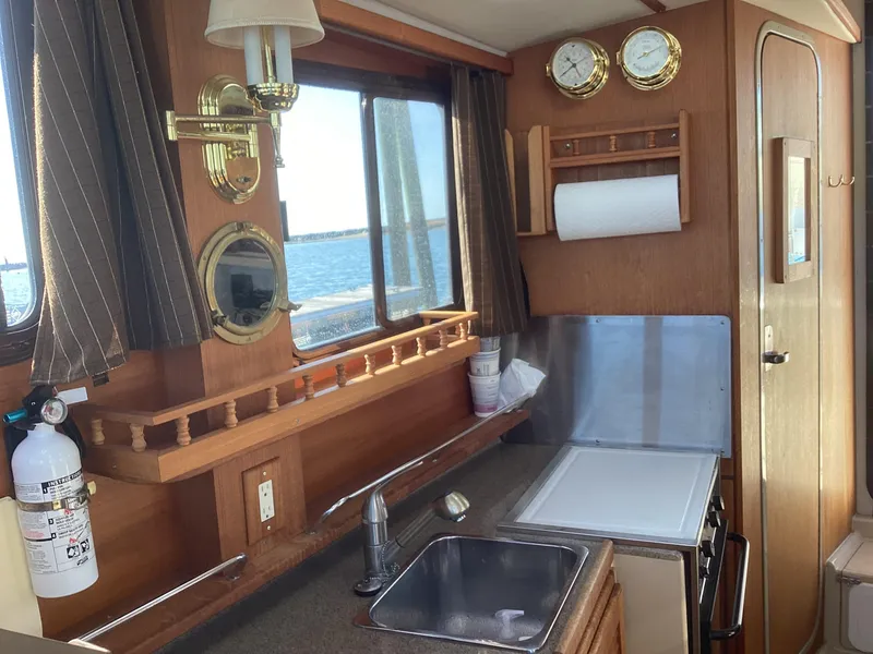 Slide: The Image of Interior of 2012 Ranger Tugs R-27 boat with kitchen sink, window, and nautical decor. - 24