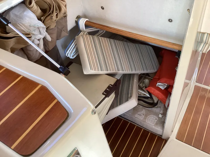 Slide: The Image of Interior storage area of 2012 Ranger Tugs R-27 boat with striped cushions and life jacket. - 29