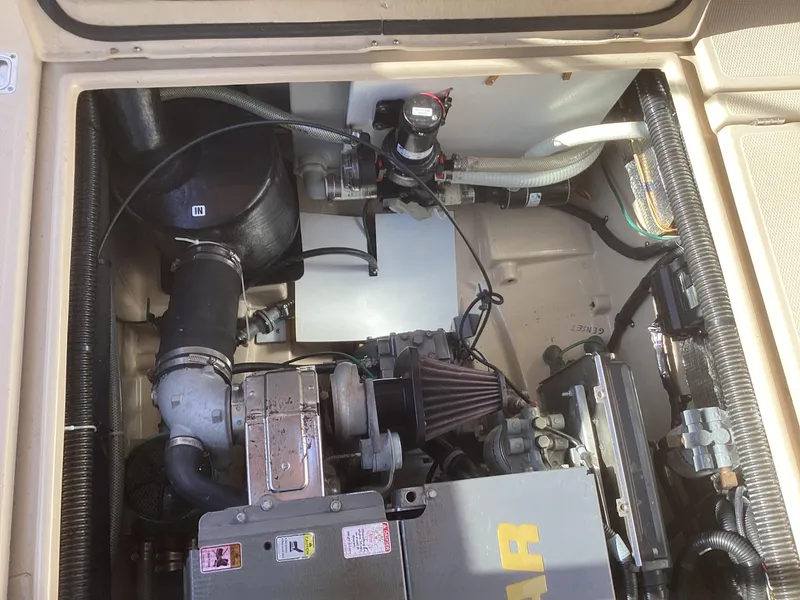 Slide: The Image of Engine compartment of a 2012 Ranger Tugs R-27 boat, showcasing mechanical components. - 37