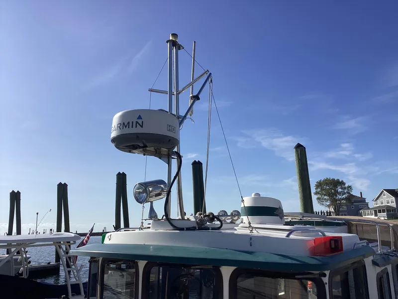 Slide: The Image of 2012 Ranger Tugs R-27 boat with Garmin radar, docked under clear blue sky. - 4