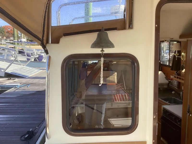 Slide: The Image of 2012 Ranger Tugs R-27 boat interior with bell and window view. - 42