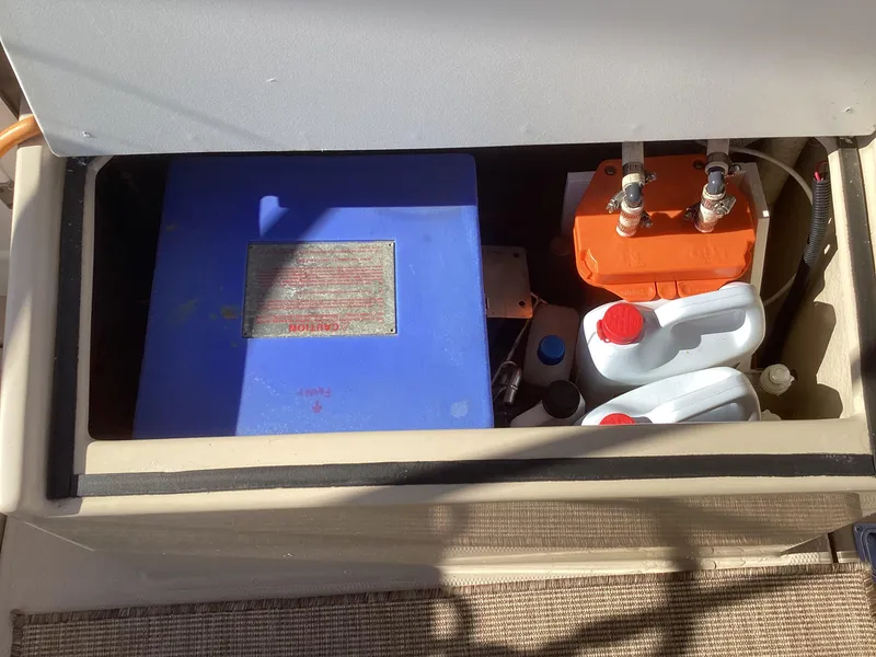 Slide: The Image of Storage compartment in a 2012 Ranger Tugs R-27 with battery and containers. - 9