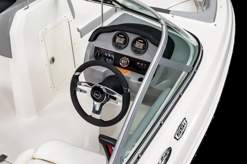 Slide: The Image of 2025 Chaparral 19 SSi OB boat dashboard with steering wheel and gauges. - 11