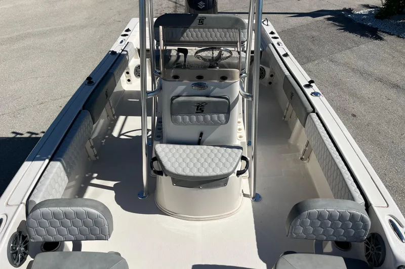 Slide: The Image of 2025 Carolina Skiff 21 Ultra Elite boat interior with gray seating and steering console. - 13