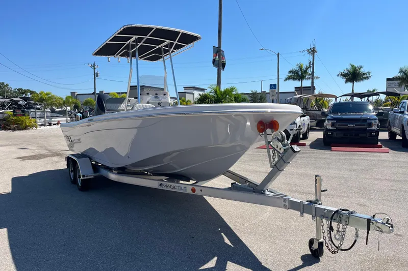 Slide: The Image of 2025 Carolina Skiff 21 Ultra Elite boat on trailer in sunny dealership lot. - 2