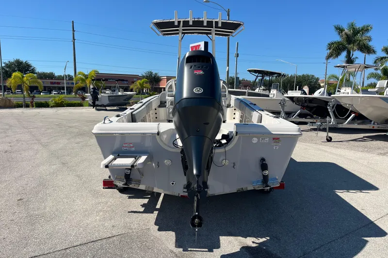 Slide: The Image of 2025 Carolina Skiff 21 Ultra Elite boat with outboard motor, parked outdoors. - 5
