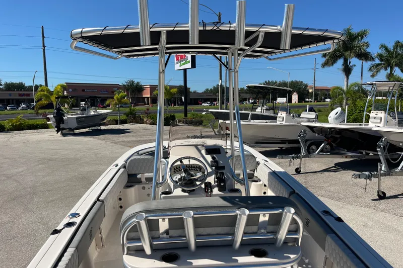 Slide: The Image of 2025 Carolina Skiff 21 Ultra Elite boat with T-top, parked outdoors under clear blue sky. - 8